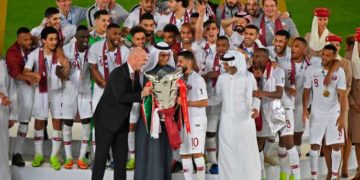 FIFA President Gianni Infantino (L) and AFC President Salman Al-Khalifa (2nd-L) present the cup to Qatar's forward Hasan Al Haydos (2nd-R) during the 2019 AFC Asian Cup final football match between Japan and Qatar at the Mohammed Bin Zayed Stadium in Abu Dhabi on February 1, 2019.  / AFP / Khaled DESOUKI