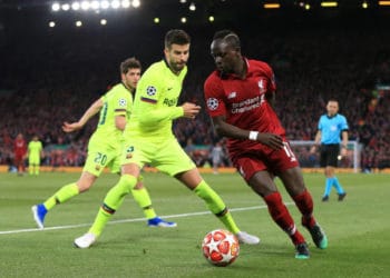 LIVERPOOL, ENGLAND - MAY 07: Sadio Mane of Liverpool battles with Gerard Pique of Barcelona during the UEFA Champions League Semi Final second leg match between Liverpool and FC Barcelona at Anfield on May 7, 2019 in Liverpool, England. (Photo by Simon Stacpoole/Offside/Getty Images)
