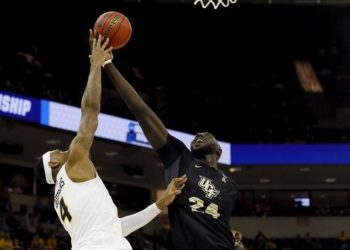 COLUMBIA, SOUTH CAROLINA - MARCH 22: Corey Douglas #4 of the Virginia Commonwealth Rams and Tacko Fall #24 of the UCF Knights battle for the rebound in the second half during the first round of the 2019 NCAA Men's Basketball Tournament at Colonial Life Arena on March 22, 2019 in Columbia, South Carolina.   Kevin C. Cox/Getty Images/AFP
== FOR NEWSPAPERS, INTERNET, TELCOS & TELEVISION USE ONLY ==
