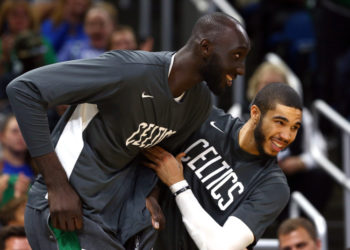 Oct 11, 2019; Orlando, FL, USA; Boston Celtics forward Jayson Tatum (0) reacts with center Tacko Fall (99) as fans cheer his name during the second half against the Orlando Magic at Amway Center. Mandatory Credit: Kim Klement-USA TODAY Sports