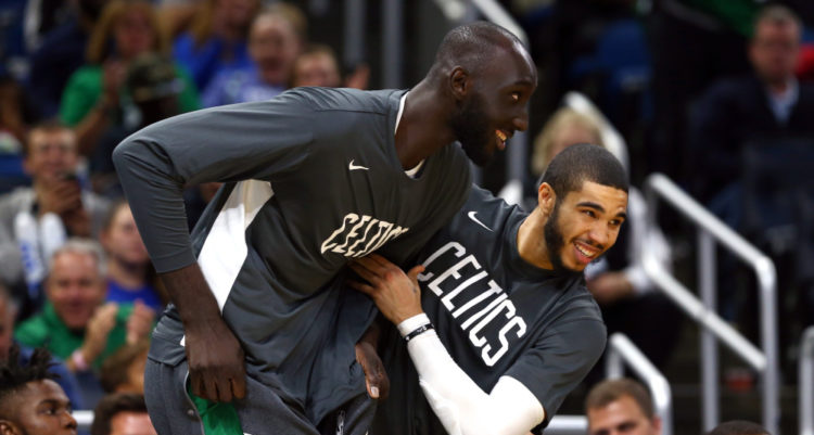 Oct 11, 2019; Orlando, FL, USA; Boston Celtics forward Jayson Tatum (0) reacts with center Tacko Fall (99) as fans cheer his name during the second half against the Orlando Magic at Amway Center. Mandatory Credit: Kim Klement-USA TODAY Sports