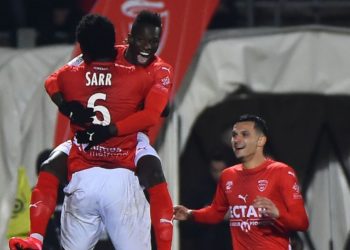Nimes's french forward Moussa Kone (2ndL) celebrates with teammates after scoring a goal during the French Ligue 1 football match between Nimes and Angers on February 15, 2020, at the Costieres stadium in Nimes. (Photo by Sylvain THOMAS / AFP) (Photo by SYLVAIN THOMAS/AFP via Getty Images)