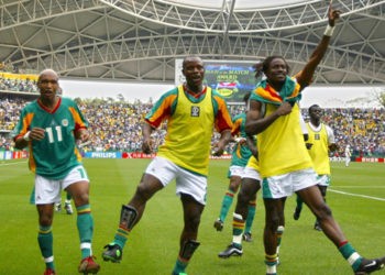 OITA, JAPAN:  (From L-R) Senegal's forward El Hadji Diouf, forward Amara Traore and defender Ferdinand Coly celebrate after Senegal qualified for the quarterfinals with a 2-1 victory over Sweden in overtime of match 51 round of 16 of the 2002 FIFA World Cup Korea Japan 16 June, 2002 in Oita, Japan. AFP PHOTO PATRICK HERTZOG (Photo credit should read PATRICK HERTZOG/AFP/Getty Images)