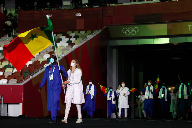 TOKYO, JAPAN - JULY 23: Flag bearers Jeanne Boutbien and Mbagnick Ndiaye of Team Senegal lead their team out during the Opening Ceremony of the Tokyo 2020 Olympic Games at Olympic Stadium on July 23, 2021 in Tokyo, Japan. (Photo by Jamie Squire/Getty Images)