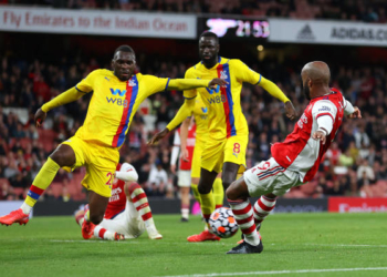 LONDON, ENGLAND - OCTOBER 18: Alexandre Lacazette of Arsenal scores their team's second goal past Christian Benteke of Crystal Palace during the Premier League match between Arsenal and Crystal Palace at Emirates Stadium on October 18, 2021 in London, England. (Photo by Catherine Ivill/Getty Images)