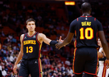 MIAMI, FL - OCTOBER 4: Bogdan Bogdanovic #13 of the Atlanta Hawks high-fives teammate Gorgui Dieng #10 during a preseason game against the Miami Heat on October 4, 2021 at FTX Arena in Miami, Florida. NOTE TO USER: User expressly acknowledges and agrees that, by downloading and or using this Photograph, user is consenting to the terms and conditions of the Getty Images License Agreement. Mandatory Copyright Notice: Copyright 2021 NBAE (Photo by Michael Reaves/NBAE via Getty Images)