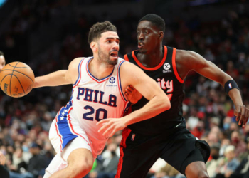 PORTLAND, OREGON - NOVEMBER 20: Georges Niang #20 of the Philadelphia 76ers works towards the basket against Tony Snell #17 of the Portland Trail Blazers during the fourth quarter at Moda Center on November 20, 2021 in Portland, Oregon. NOTE TO USER: User expressly acknowledges and agrees that, by downloading and or using this photograph, User is consenting to the terms and conditions of the Getty Images License Agreement.  (Photo by Abbie Parr/Getty Images)