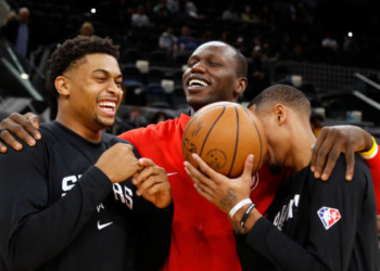 SAN ANTONIO, TX - NOVEMBER 24:  Keldon Johnson #3 and Dejounte Murray #5 of the San Antonio Spurs joke with Gorgui Dieng #10 of the Atlanta Hawks before a game at AT&T Center on November 24, 2021 in San Antonio, Texas.  NOTE TO USER: User expressly acknowledges and agrees that , by downloading and or using this photograph, User is consenting to the terms and conditions of the Getty Images License Agreement. (Photo by Ronald Cortes/Getty Images)