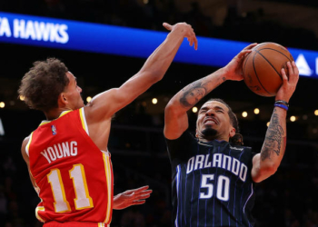 ATLANTA, GEORGIA - NOVEMBER 15:  Cole Anthony #50 of the Orlando Magic draws a foul from Trae Young #11 of the Atlanta Hawks during the second half at State Farm Arena on November 15, 2021 in Atlanta, Georgia.  NOTE TO USER: User expressly acknowledges and agrees that, by downloading and or using this photograph, User is consenting to the terms and conditions of the Getty Images License Agreement.  (Photo by Kevin C. Cox/Getty Images)