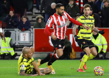 Soccer Football - Premier League - Brentford v Watford - Brentford Community Stadium, London, Britain - December 10, 2021 Watford's William Troost-Ekong fouls Brentford's Saman Ghoddos to concede a penalty REUTERS/David Klein EDITORIAL USE ONLY. No use with unauthorized audio, video, data, fixture lists, club/league logos or 'live' services. Online in-match use limited to 75 images, no video emulation. No use in betting, games or single club /league/player publications.  Please contact your account representative for further details.
