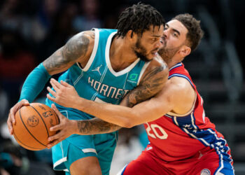 CHARLOTTE, NORTH CAROLINA - DECEMBER 08: Miles Bridges #0 of the Charlotte Hornets is guarded by Georges Niang #20 of the Philadelphia 76ers in the fourth quarter during their game at Spectrum Center on December 08, 2021 in Charlotte, North Carolina. NOTE TO USER: User expressly acknowledges and agrees that, by downloading and or using this photograph, User is consenting to the terms and conditions of the Getty Images License Agreement. (Photo by Jacob Kupferman/Getty Images)