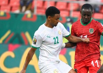 Malawi's forward Gabadinho Mhango (2nd L) controls the ball as Senegal's defender Abdou Diallo (L), Senegal's defender Kalidou Koulibaly (2nd R) and Senegal's goalkeeper Edouard Mendy (R) defend during the Group B Africa Cup of Nations (CAN) 2021 football match between Malawi and Senegal at Stade de Kouekong in Bafoussam on January 18, 2022. (Photo by Pius Utomi EKPEI / AFP) (Photo by PIUS UTOMI EKPEI/AFP via Getty Images)
