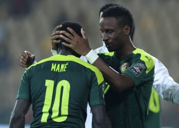 Senegal's forward Sadio Mane (L) celebrates with Senegal's defender Bouna Sarr after scoring his team's third goal during the Africa Cup of Nations (CAN) 2021 semi final football match between Burkina Faso and Senegal at Stade Ahmadou-Ahidjo in Yaounde on February 2, 2022. (Photo by Kenzo Tribouillard / AFP) (Photo by KENZO TRIBOUILLARD/AFP via Getty Images)