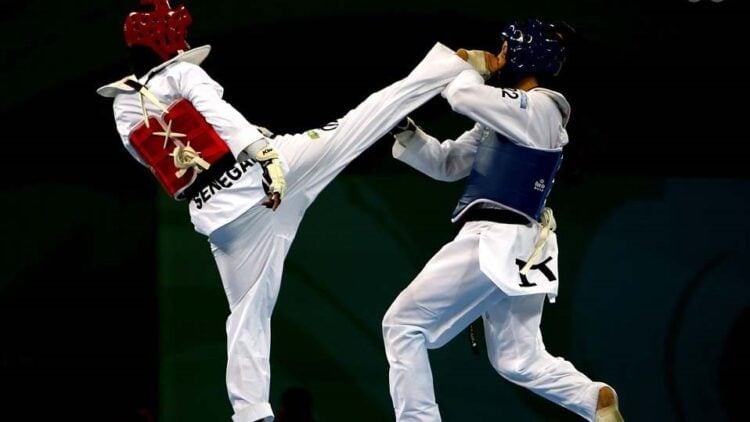 BEIJING - AUGUST 21:  Veronica Calabrese of Italy (blue) fights Bineta Diedhiou of Senegal (red) in the Women -57kg Quarterfinal match held at the Beijing Science and Technology University Gymnasium during Day 13 of the Beijing 2008 Olympic Games on August 21, 2008 in Beijing, China.  (Photo by Clive Rose/Getty Images)