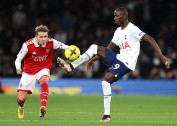 LONDON, ENGLAND - JANUARY 15: Pape Matar Sarr of Tottenham Hotspur is challenged by Martin Odegaard of Arsenal during the Premier League match between Tottenham Hotspur and Arsenal FC at Tottenham Hotspur Stadium on January 15, 2023 in London, England. (Photo by Catherine Ivill/Getty Images)