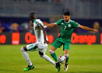 Senegal's Cheikhou Kouyate (L) in action against Algeria's Riyad Mahrez (R) during the 2019 Africa Cup of Nations (AFCON) group C soccer match between Senegal and Algeria at 30 June Stadium in Cairo, Egypt, 27 June 2019. (Photo by Mohamed Mostafa/NurPhoto via Getty Images)