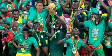 Soccer Football - Africa Cup of Nations - Final - Senegal v Egypt - Olembe Stadium, Yaounde, Cameroon - February 6, 2022 Senegal's Kalidou Koulibaly lifts the trophy as he celebrates with teammates after winning the Africa Cup of Nations || 220452_0240