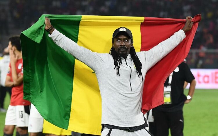 Senegal's head coach Aliou Cisse holds a Senegalese flag as he celebrates after winning the Africa Cup of Nations (CAN) 2021 final football match between Senegal and Egypt at Stade d'Olembe in Yaounde on February 6, 2022. (Photo by CHARLY TRIBALLEAU / AFP)