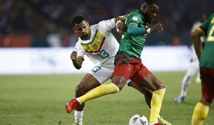 Senegal's forward #13 Iliman Ndiaye fights for the ball with Cameroon's midfielder #22 Olivier Ntcham during the Africa Cup of Nations (CAN) 2024 group C football match between Senegal and Cameroon at the Stade Charles Konan Banny in Yamoussoukro on January 19, 2024. (Photo by KENZO TRIBOUILLARD / AFP)