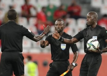 DOHA, QATAR - FEBRUARY 11: Match referee Maguette Ndiaye interacts with assistant referees El Hadji Samba and Djibril Camara as they walk off the pitch at half-time during the FIFA Club World Cup Qatar 2020 3rd Place Play off match between Al Ahly and SE Palmeiras at the Education City Stadium on February 11, 2021 in Doha, Qatar. (Photo by Fadi El Assaad - FIFA/FIFA via Getty Images)