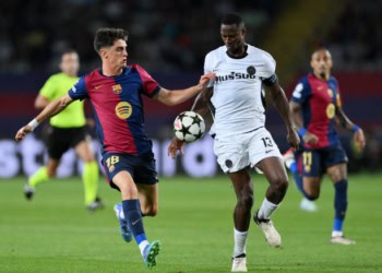 BARCELONA, SPAIN - OCTOBER 01: Pau  of Bayer 04 Leverkusen is challenged by Mohamed Camara of BSC Young Boys during the UEFA Champions League 2024/25 League Phase MD2 match between FC Barcelona and BSC Young Boys at Estadi Olimpic Lluis Companys on October 01, 2024 in Barcelona, Spain. (Photo by David Ramos/Getty Images)