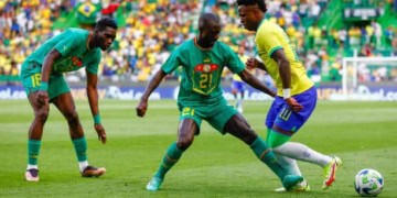 LISBON, PORTUGAL - JUNE 20: Youssouf Sabaly of Senegal and Vinicius Jr of Brazil battle for the ball during the International Friendly match betwen Brazil and Senegal at Estadio Jose Alvalade on June 20, 2023 in Lisbon, Portugal. (Photo by Joao Rico/DeFodi Images via Getty Images)