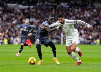MADRID, SPAIN - MARCH 09: Jude Bellingham of Real Madrid and Pathe Ciss of Rayo Vallecano in action during the Spanish League, LaLiga EA Sports, football match played between Real Madrid and Rayo Vallecano at Santiago Bernabeu stadium on March 09, 2025, in Madrid, Spain. (Photo By Oscar J. Barroso/Europa Press via Getty Images)