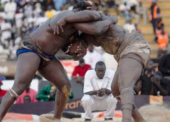 Yekini (left) and Balla Gaye 2 (right) lock arms during the title laamb match at Demba Diop Stadium in Dakar, Senegal, April 22, 2012.                              NYTCREDIT: Joe Penney for The New York Times