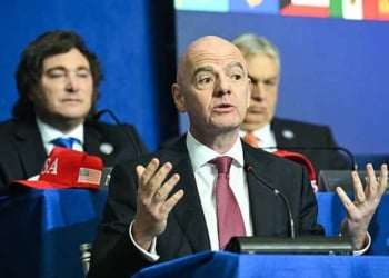 (L/R) Argentina's President Javier Milei looks on as FIFA President Gianni Infantino speaks during the inaugural meeting of the "Board of Peace" hosted by US President Donald Trump at the US Institute of Peace in Washington, DC, on February 19, 2026. President Trump on Thursday gathers allies to inaugurate the "Board of Peace," his new institution focused on progress on Gaza but whose ambitions reach much further. Around two dozen world leaders or other senior officials have come to Washington for the meeting -- including several of Trump's authoritarian-leaning friends and virtually none of the European democrats that traditionally sign on to US initiatives. (Photo by SAUL LOEB / AFP via Getty Images)