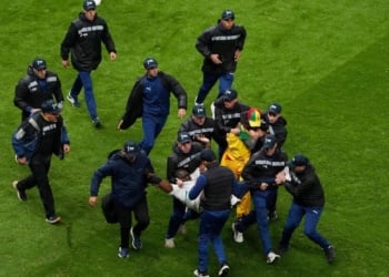 FILE PHOTO: Soccer Football - CAF Africa Cup of Nations - Morocco 2025 - Final - Senegal v Morocco - Prince Moulay Abdellah Stadium, Rabat, Morocco - January 18, 2026
Security staff tackle Senegal fans who invaded the pitch after Morocco were awarded a penalty following a VAR review REUTERS/Stringer/File Photo