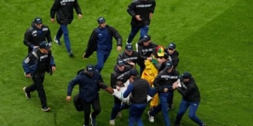 FILE PHOTO: Soccer Football - CAF Africa Cup of Nations - Morocco 2025 - Final - Senegal v Morocco - Prince Moulay Abdellah Stadium, Rabat, Morocco - January 18, 2026
Security staff tackle Senegal fans who invaded the pitch after Morocco were awarded a penalty following a VAR review REUTERS/Stringer/File Photo