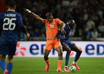 Ivory Coast's defender #20 Emmanuel Agbadou (L) and France's forward #22 Jean Mateta (R) fight for the ball during the international friendly football match between France and Ivory Coast ahead of the 2026 FIFA World Cup football tournament at the Stade de la Beaujoire in Nantes, western France, on June 4, 2026. (Photo by Loic VENANCE / AFP via Getty Images)