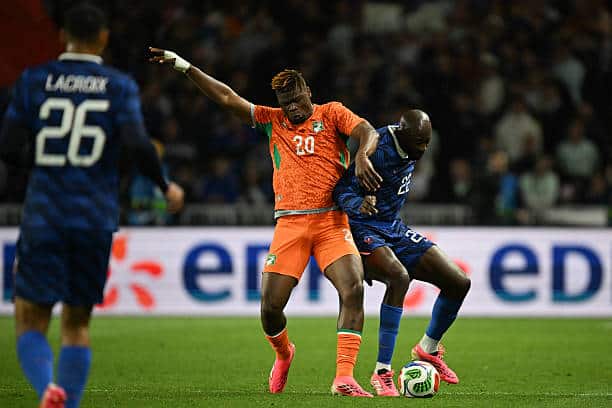 Ivory Coast's defender #20 Emmanuel Agbadou (L) and France's forward #22 Jean Mateta (R) fight for the ball during the international friendly football match between France and Ivory Coast ahead of the 2026 FIFA World Cup football tournament at the Stade de la Beaujoire in Nantes, western France, on June 4, 2026. (Photo by Loic VENANCE / AFP via Getty Images)