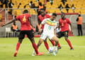 Senegal's Iliman Ndiaye (2nd R) is tackled by Mozambique's Amadu (L) during the 2023 Africa Cup of Nations (CHAN) Group L qualifier match between Senegal and Mozambique at Stade Me Abdoulaye Wade in Dakar on March 24, 2023. (Photo by John Wessels / AFP) (Photo by JOHN WESSELS/AFP via Getty Images)