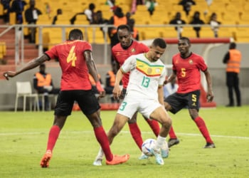 Senegal's Iliman Ndiaye (2nd R) is tackled by Mozambique's Amadu (L) during the 2023 Africa Cup of Nations (CHAN) Group L qualifier match between Senegal and Mozambique at Stade Me Abdoulaye Wade in Dakar on March 24, 2023. (Photo by John Wessels / AFP) (Photo by JOHN WESSELS/AFP via Getty Images)