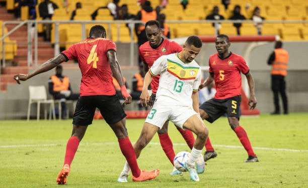 Senegal's Iliman Ndiaye (2nd R) is tackled by Mozambique's Amadu (L) during the 2023 Africa Cup of Nations (CHAN) Group L qualifier match between Senegal and Mozambique at Stade Me Abdoulaye Wade in Dakar on March 24, 2023. (Photo by John Wessels / AFP) (Photo by JOHN WESSELS/AFP via Getty Images)
